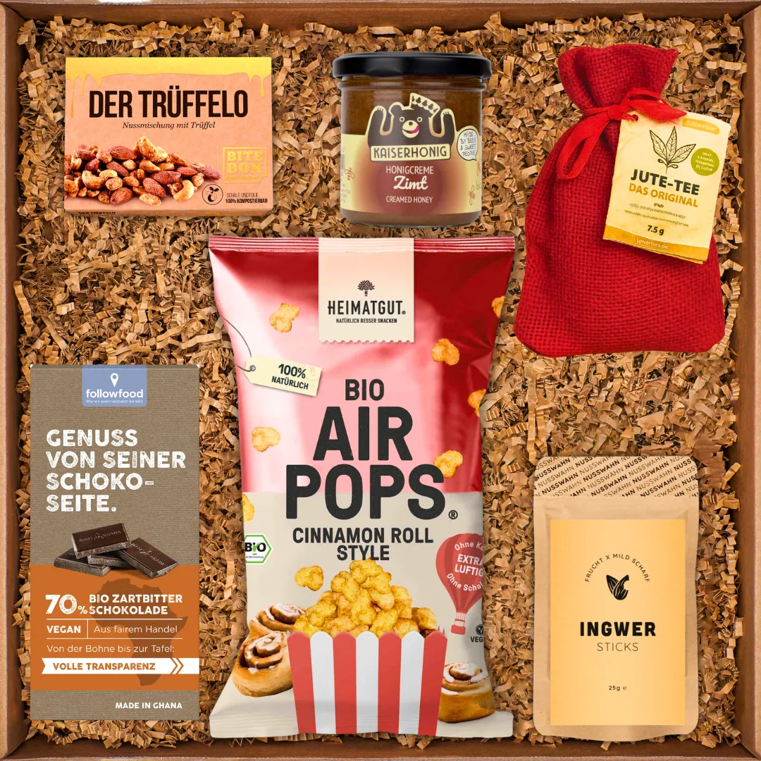 Geschenkbox mit Bio-Air-Pops, Trüffel-Nussmischung, Zimt-Honig, Jute-Tee, Zartbitterschokolade und Ingwer-Sticks.