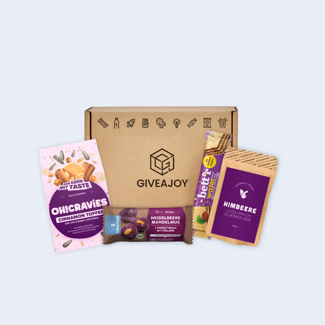 Geschenkbox von GIVEAJOY mit OH!CRAVIES Zimt, Heidelbeere Mandelmus Riegel, Himbeer Schokolade und Bett2Water Waffeln.