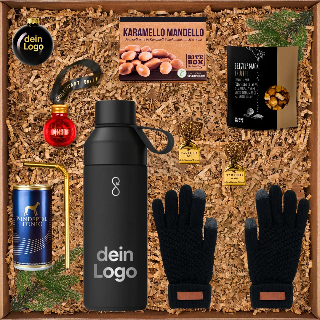 Geschenkbox mit schwarzer Flasche, Handschuhen, Tonic-Getränk, Pralinen, Brezelsnack und Zimtstange.